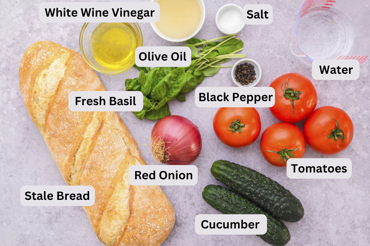 ingredients to make italian panzanella salad on counter with labels.