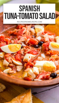 juicy salad with tuna, tomatoes, and eggs in wooden bowl with text overlay "Spanish Tuna-Tomato Salad".