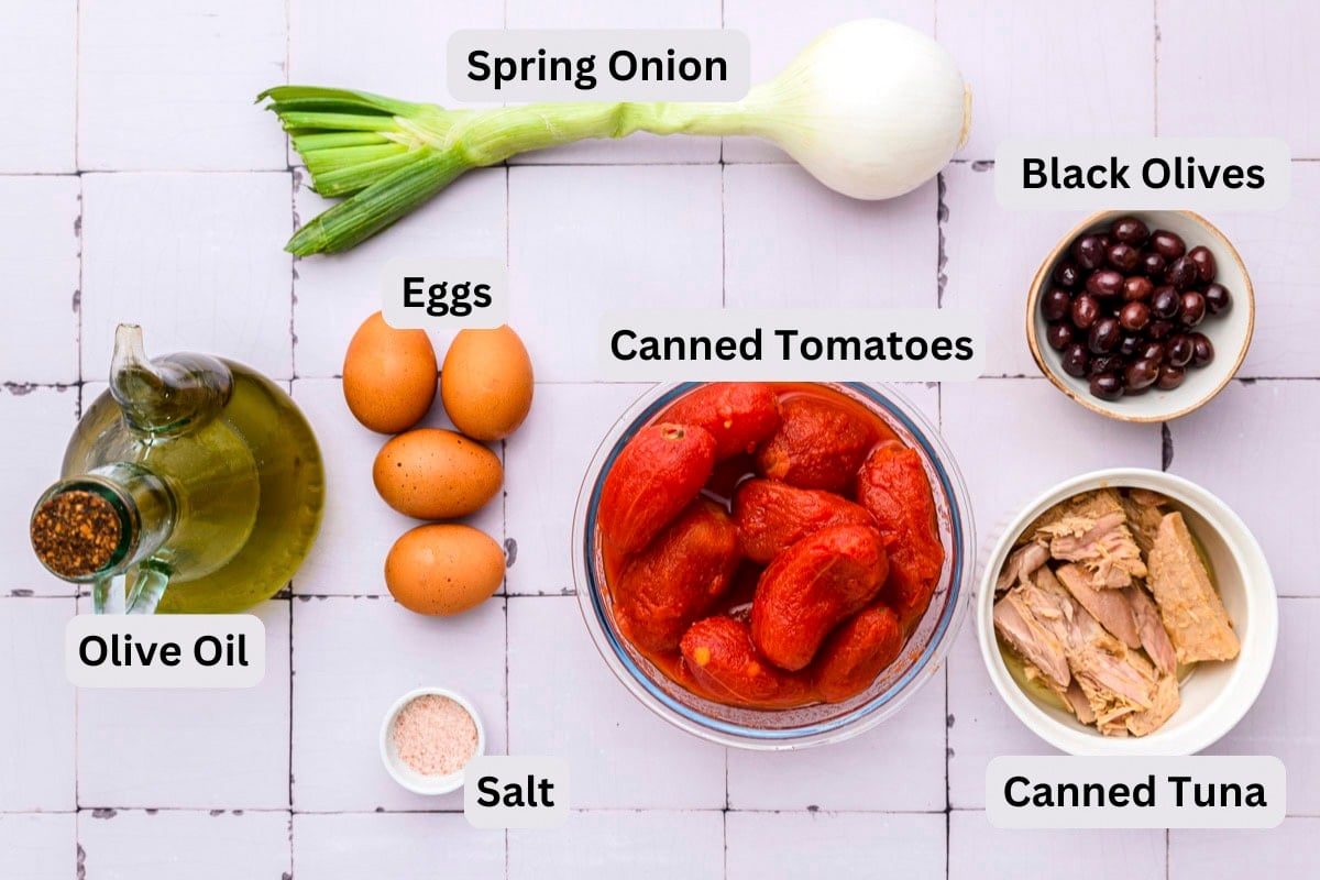 ingredients to make spanish tomato salad on counter with labels beside.