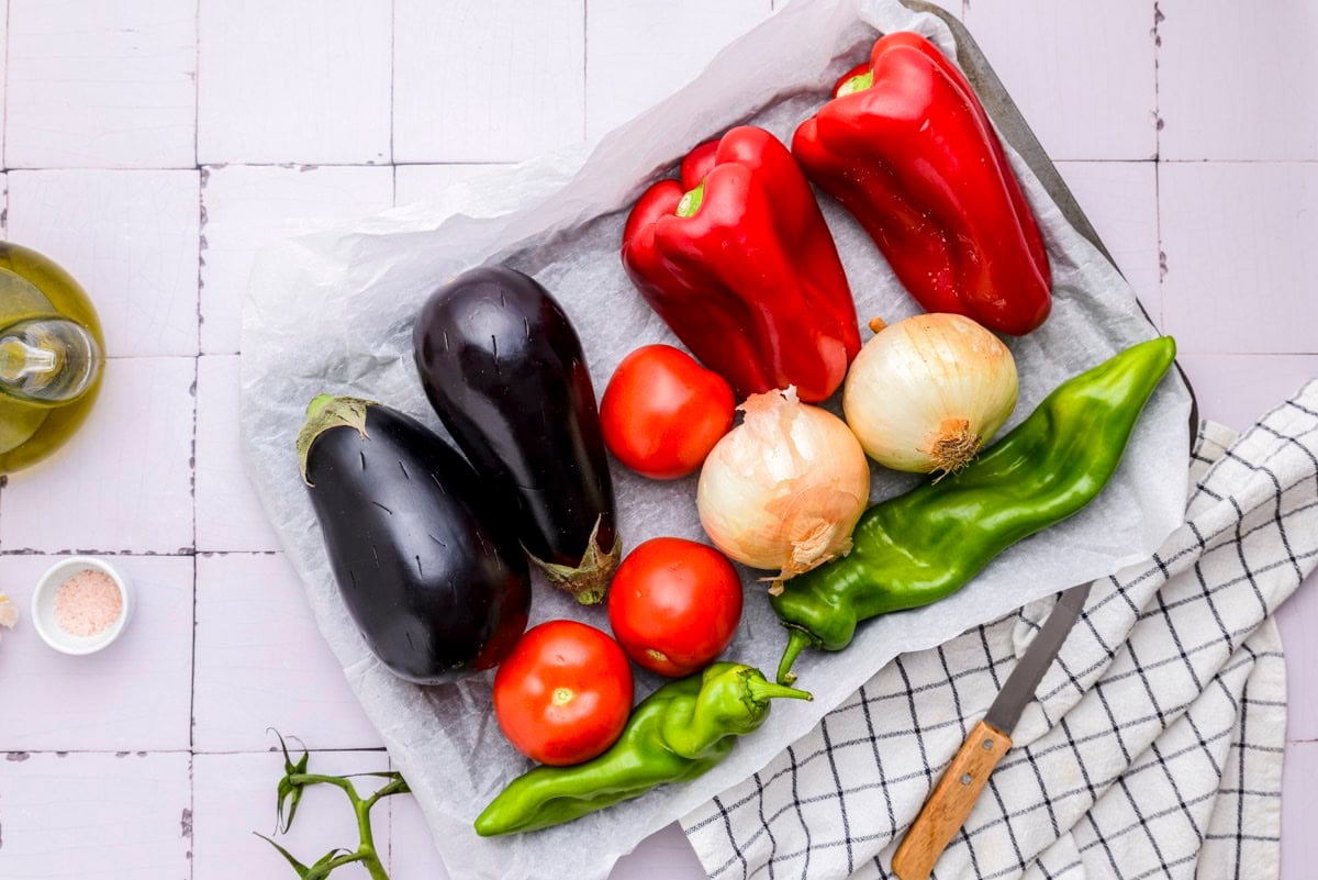 whole vegetables sitting on parchment paper tray on counter.
