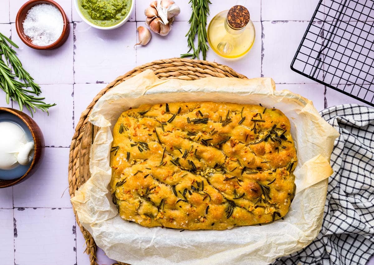 baked focaccia in pan sitting on counter.