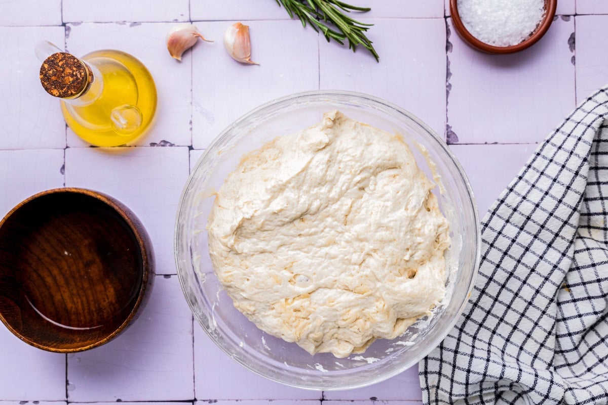 sticky dough in glass bowl on counter.