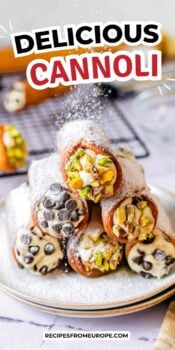 assembled cannoli stacked on plate with powderd sugar dusted on top and text overlay "delicious cannoli".