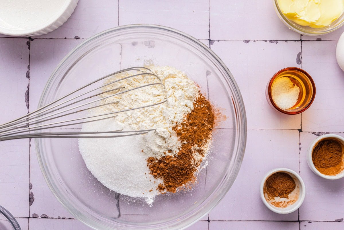 dry ingredients in bowl with whisk sticking out.