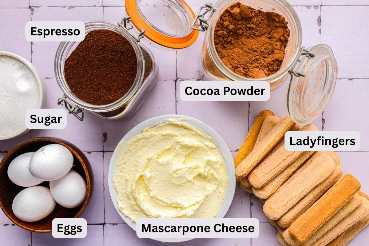 ingredients to make tiramisu on counter in bowls with labels.