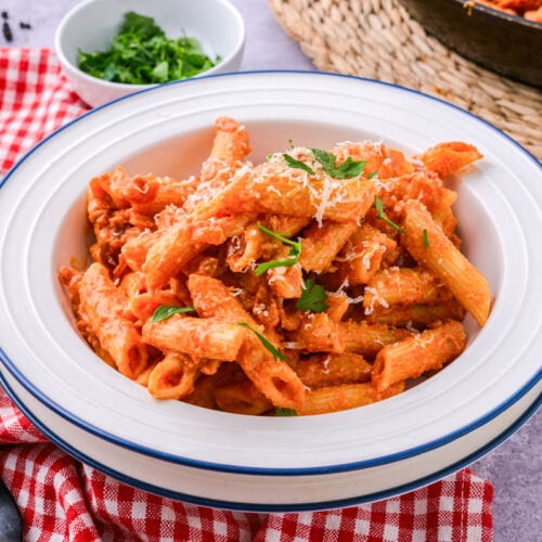 bowl of penne alla vodka on counter with cloth under.