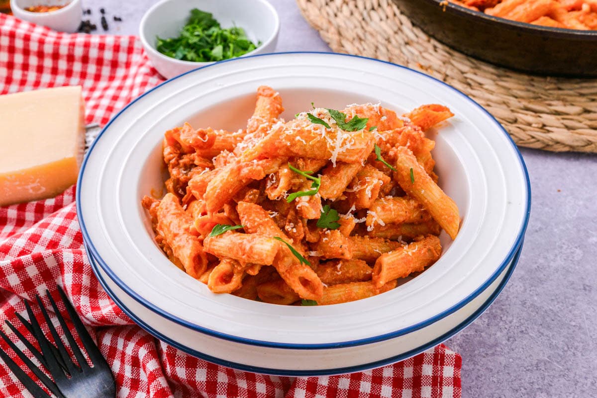 bowl of penne alla vodka on counter with cloth under.