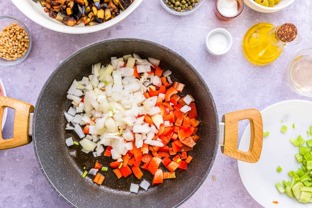 raw onions and red bell pepper diced and tossed in black frying pan.