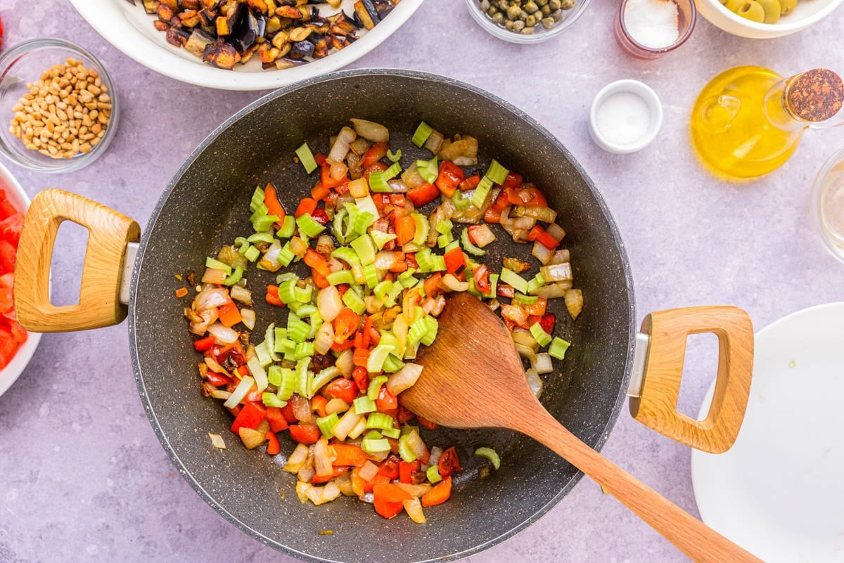 raw celery chopped and added to black frying pan of vegetables.