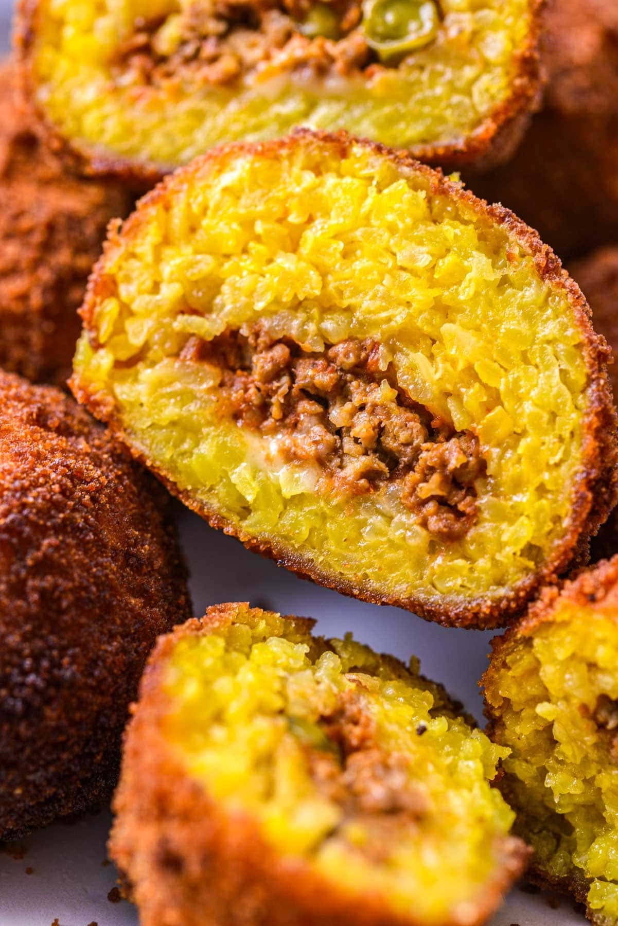 close up shot of arancini rice ball cut in half.