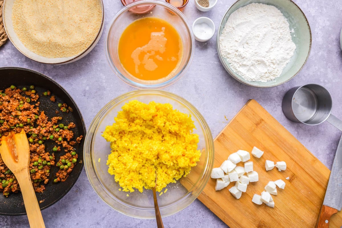 bowls of rice ball ingredients set up on counter.