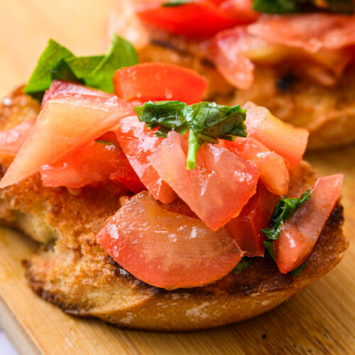tomato bruschetta on wooden board.