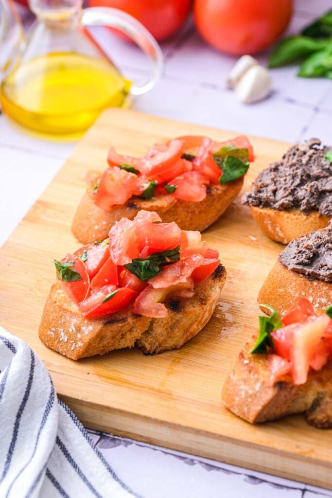 bruschetta with tomatoes and liver on wooden board.