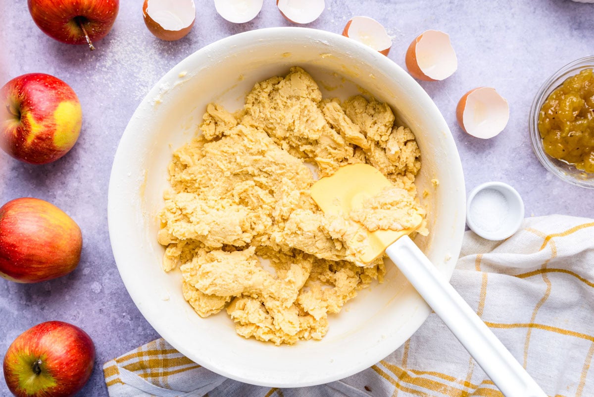 buttery dough in bowl with spatula.