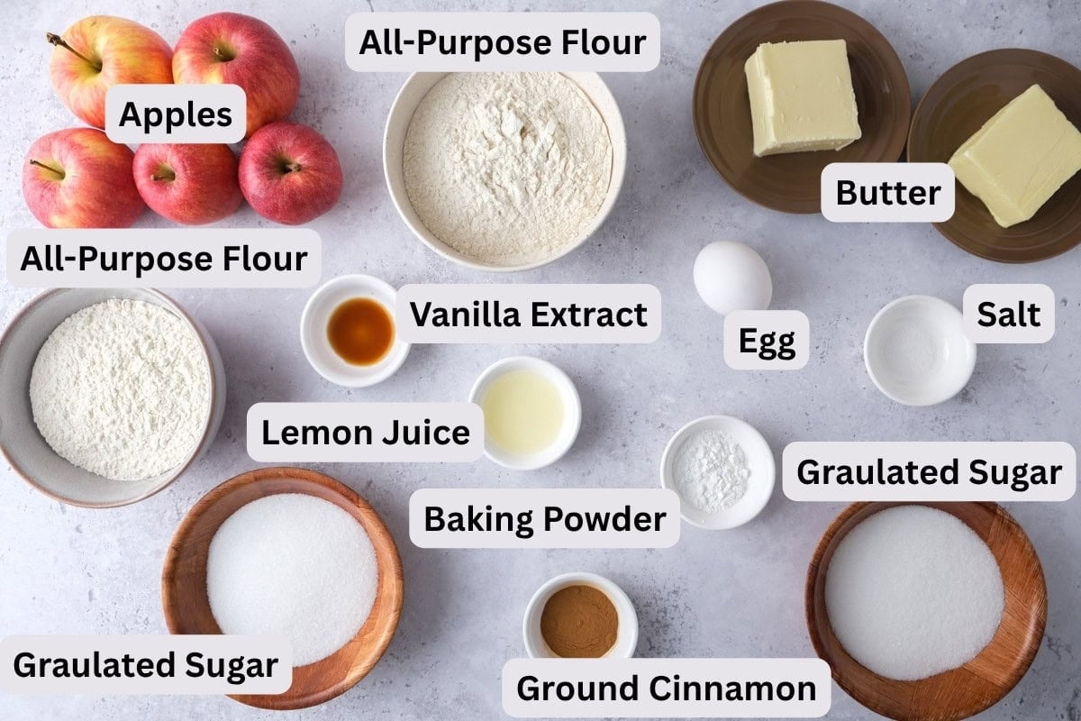 ingredients to make german apple cake in bowls on counter with labels.