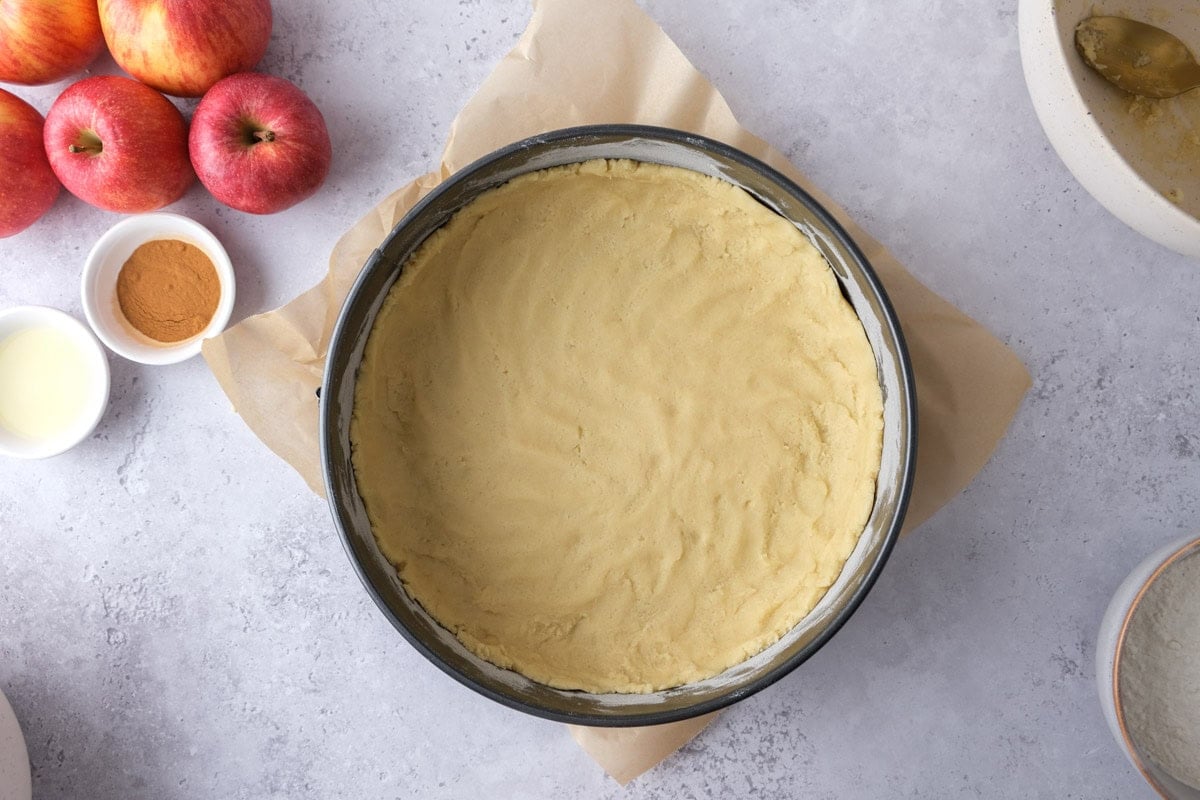 raw dough to form crust in bottom of round pan on counter.