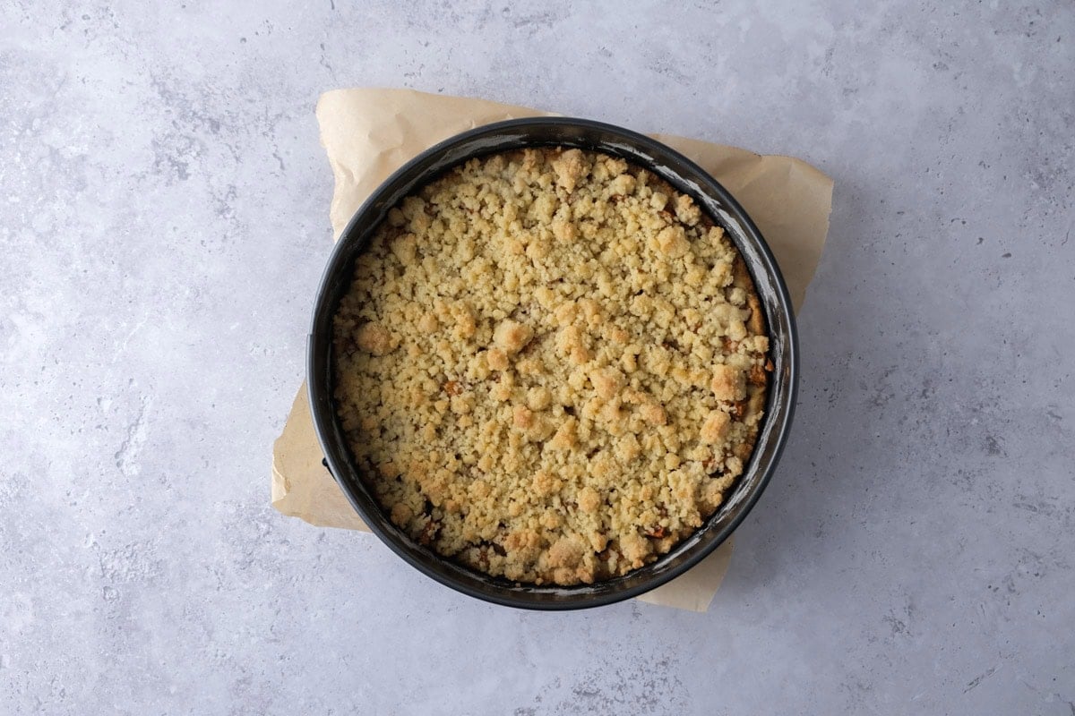 baked german apple cake with golden brown crumbs on top.