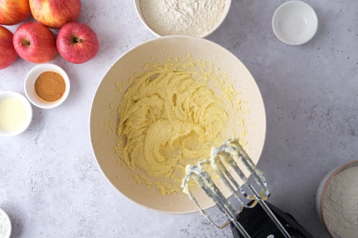 beaters resting above bowl of batter on counter.