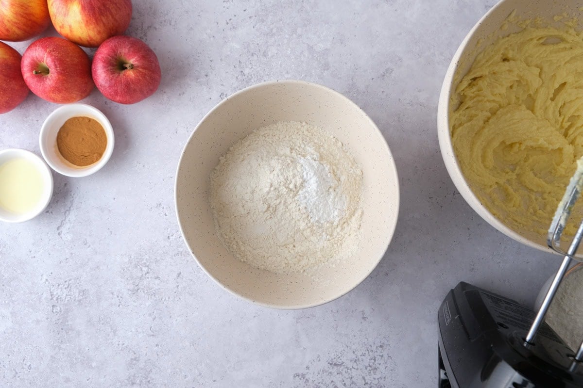 bowl of flour on counter with mixer beside.